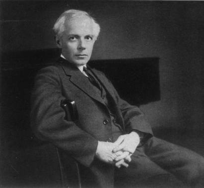 Foto von Béla Bartók (1927), im Anzug, locker auf eine Stuhl sitzend, sich auf der Stuhllehne abstützend